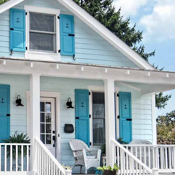 Double-hung windows with shutters on a house.