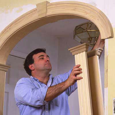 Man converting door opening into an archway.