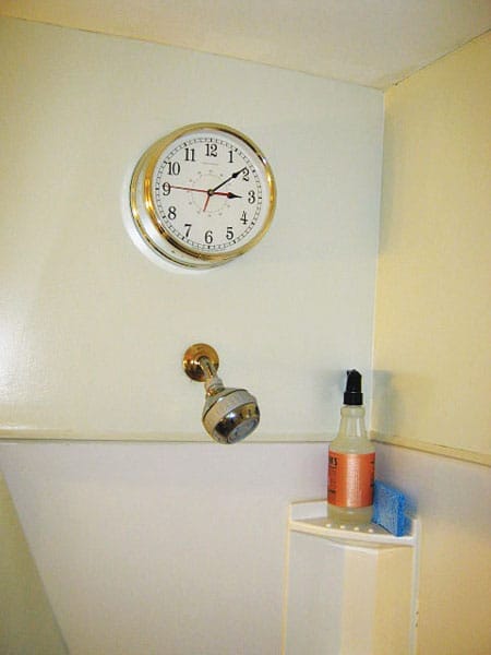 Electrical clock installed inside shower stall creating shock hazard.