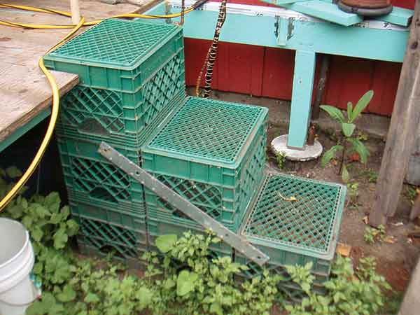 Milk crates stacked to create makeshift stairs to deck.