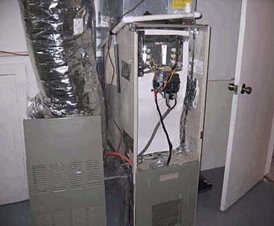 Old gas furnace shell converted to electric heat pump system.