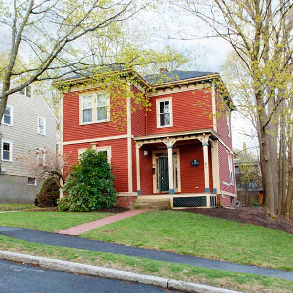 Historic 1872 Italianate house exterior with ornate corbeled cornice and original front porch.