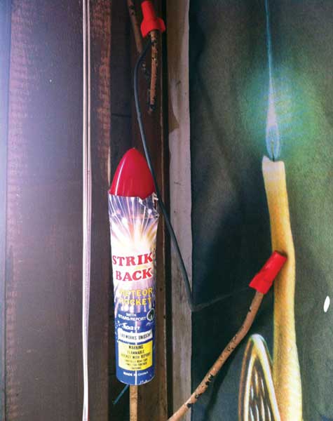 Illegal firework placed next to exposed electrical wire splice.