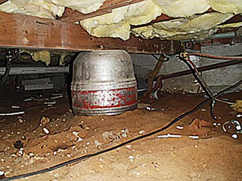 Guinness beer keg used as structural support for house girder.