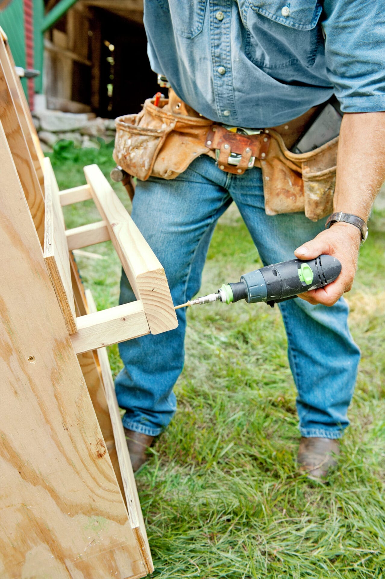 Silva adds nesting boxes to the coop frame.