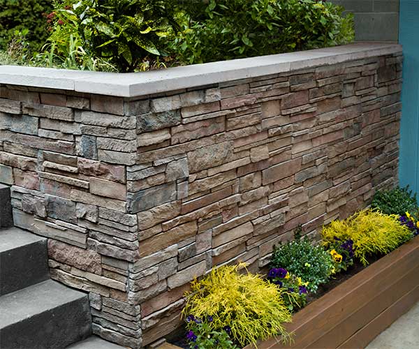 Stone-veneer paneled outdoor wall.