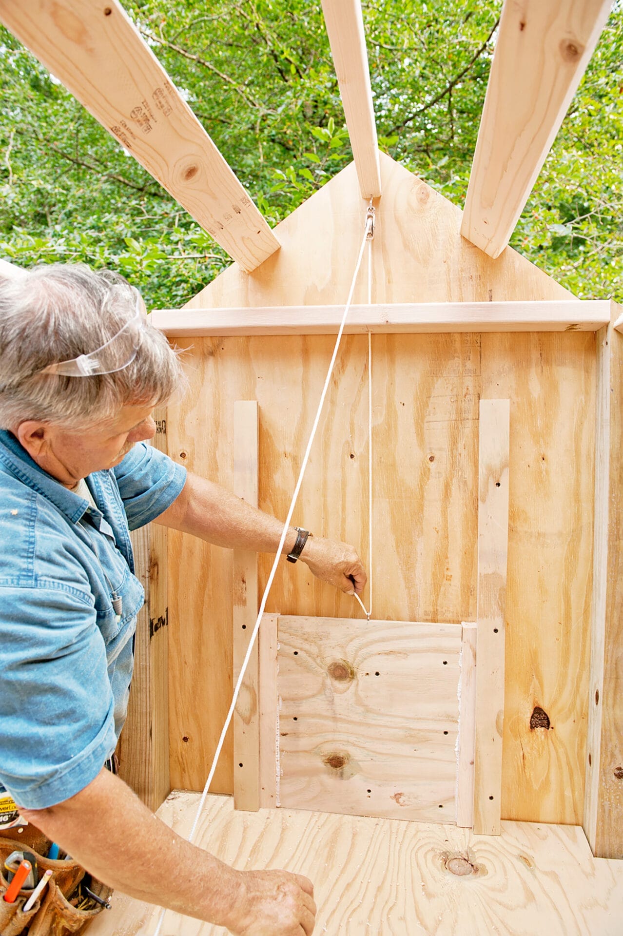 Tom Silva add a pulley system inside the coop for the door.