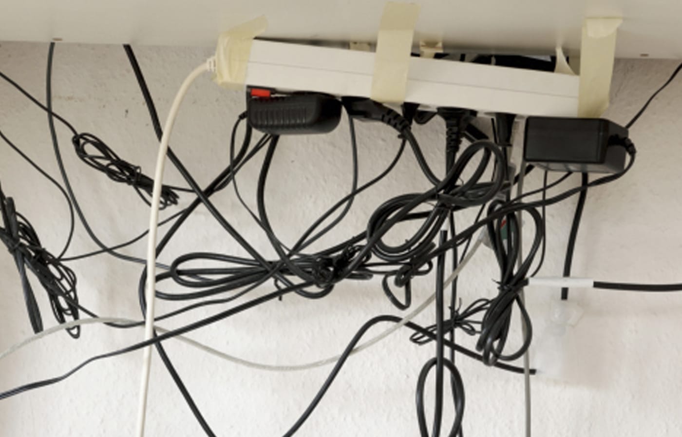 A surge protector with sever plugs plugged into it.