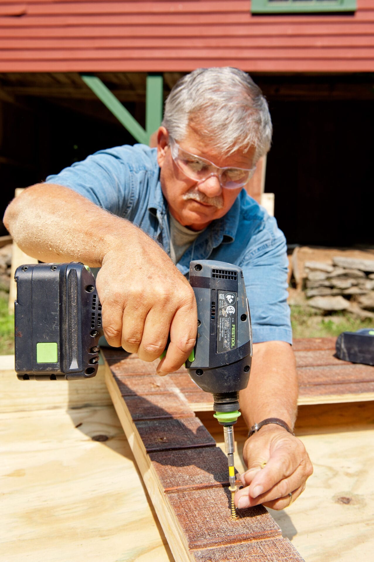 Tom Silva drills and secures supports for the chicken coop using deck screws.