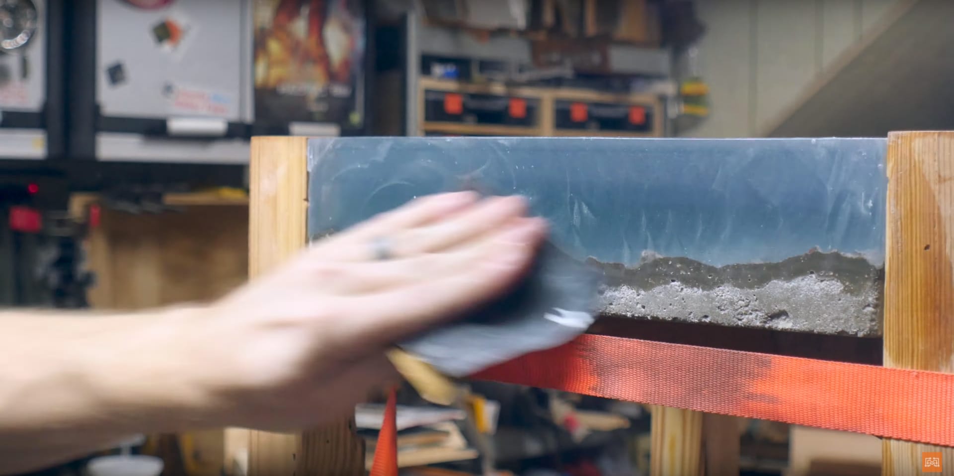 Image of someone demonstrating one of the steps of making an ocean epoxy table, which is to finish the tabletop