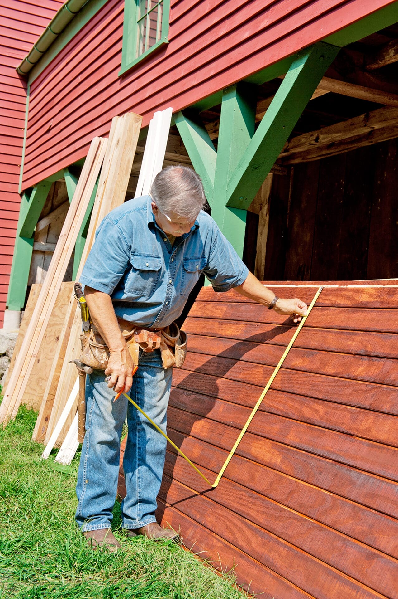 Tom Silva measures the parts needed to build a chicken coop.