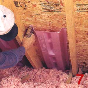 Photo of a contractor installing attic baffles to help with attic ventilation