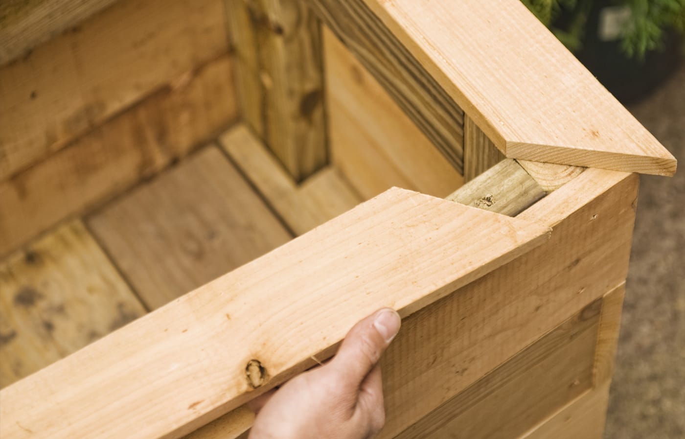 A finishing piece is placed on the top of the planter box of the privacy planter.
