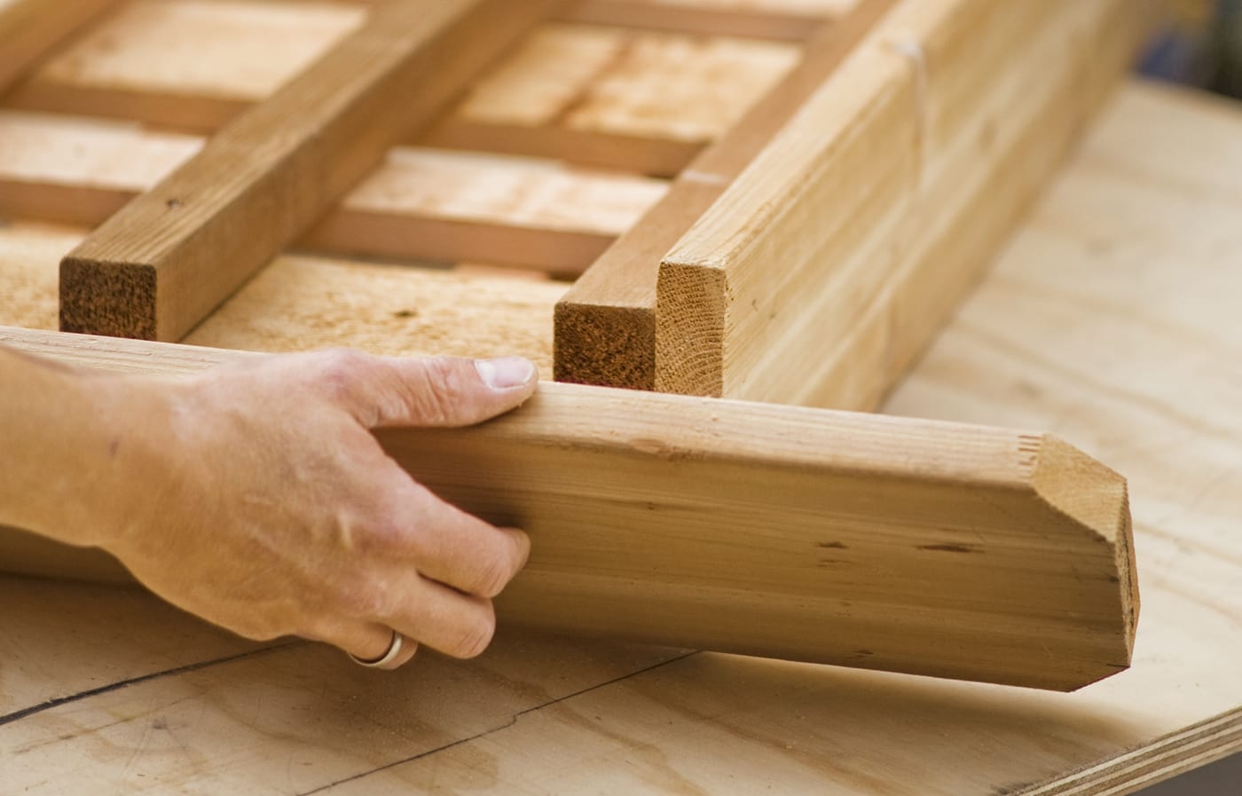 A person attaches the top trim to the privacy planter.