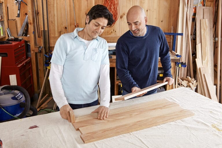 Men laying out the panels for the storage chest
