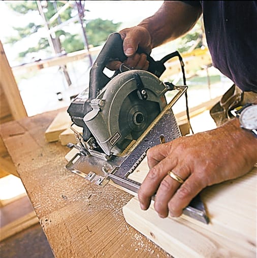 Studs are cut to length with a circular saw and speed square so they are the right size for the partition wall frame.