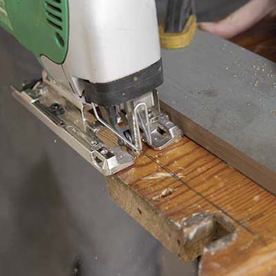 Stair tread is cut to be used in building a table.