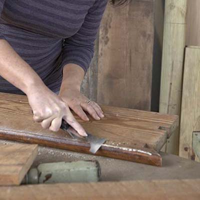 Salvaged stair parts are prepped.