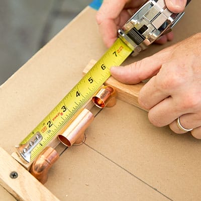 Copper tee and elbow fittings laid out on template lines.