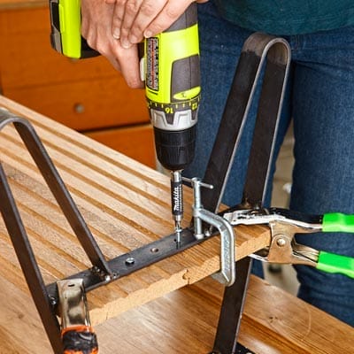 The shelf is drilled onto the legs of the cabinet door table.