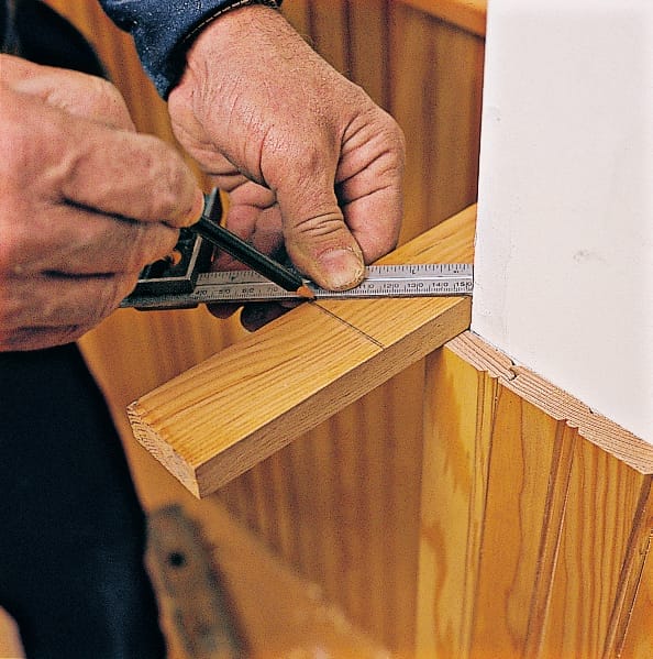 Image of a step of the beadboard wainscoting installation process, which involves marking miter cut on the rails