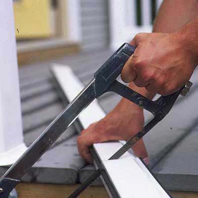 An image of a screen door being cut to fit.
