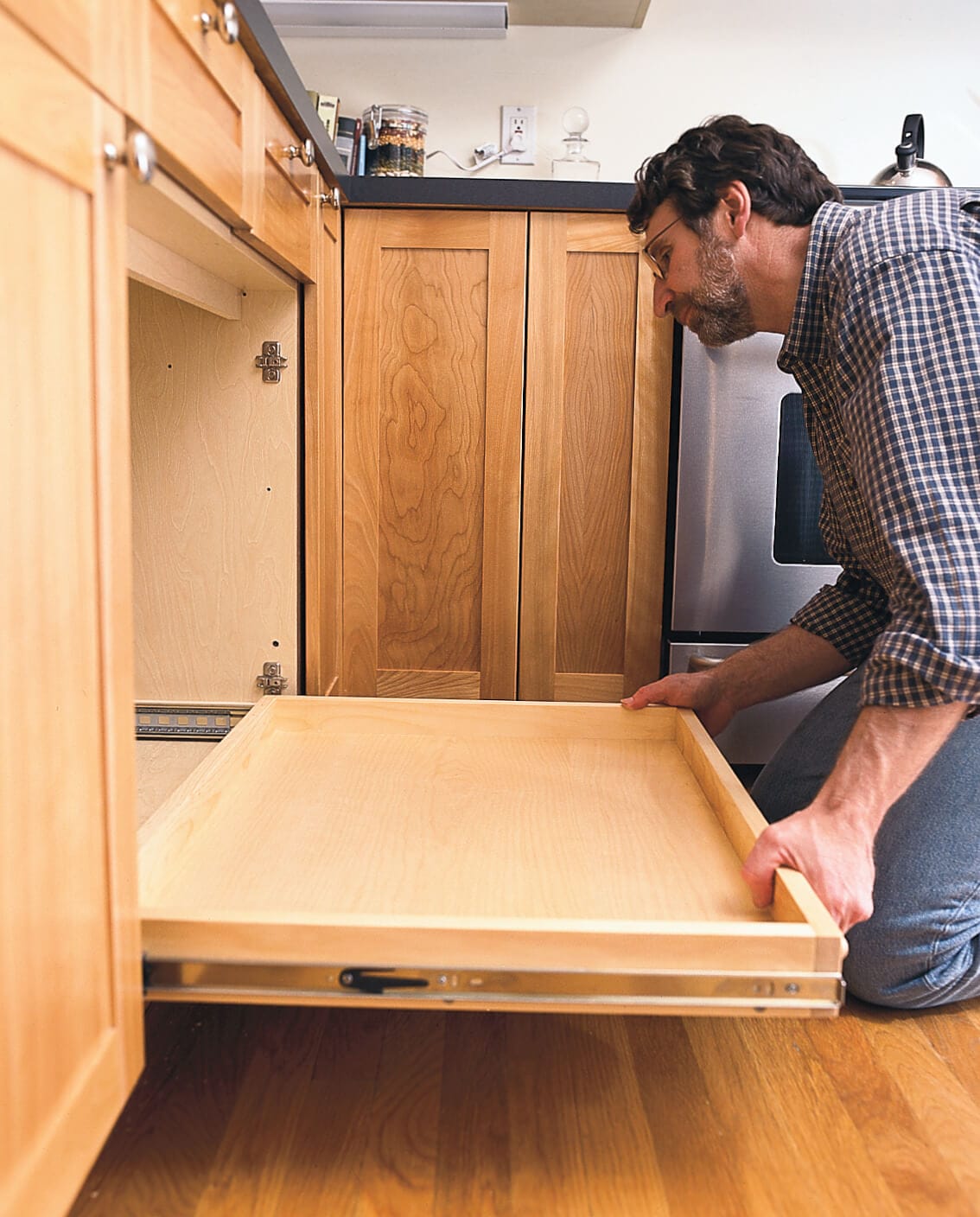 installing the pull-out kitchen shelf into the cabinet