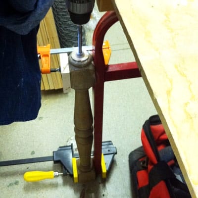 drilling a hole in a stair baluster to create a candlestick holder