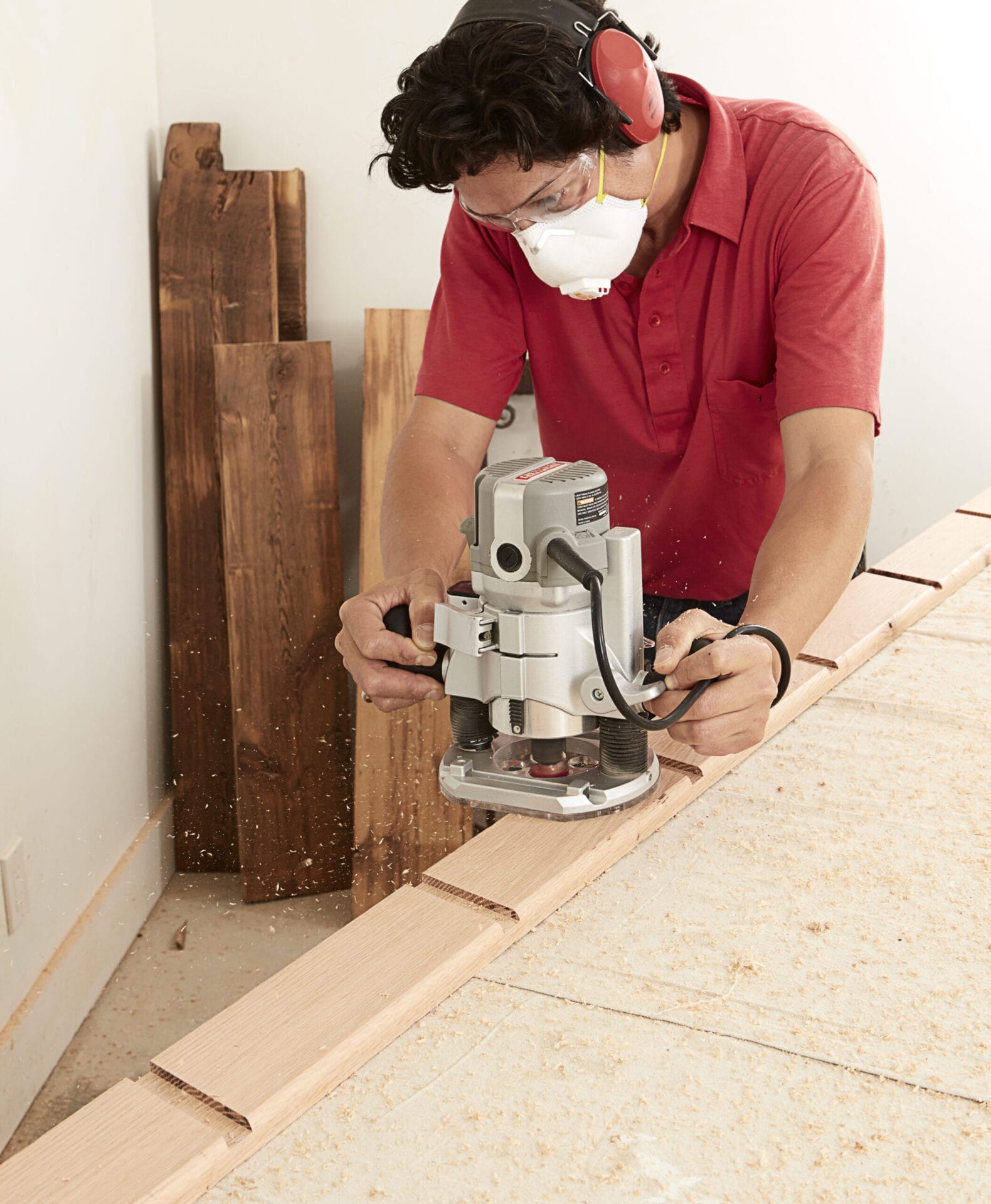 Image of a person completing a step in the DIY rolling library ladder project, which involves routing the bullnose extension
