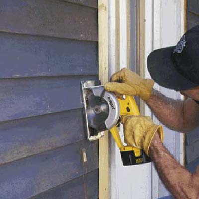 using a saw to prep for installation of exterior trim