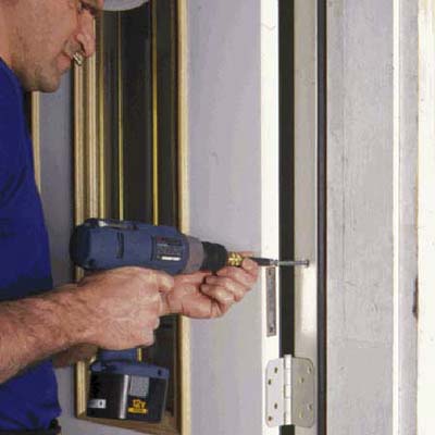 using a drill to install a door an lockset