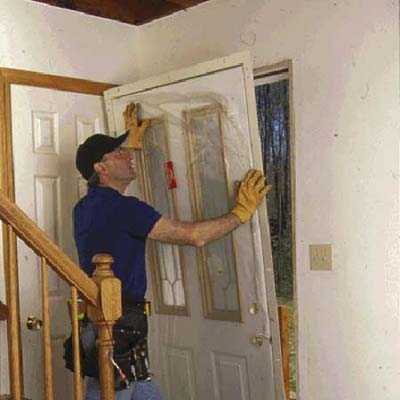 placing the new door into the opening