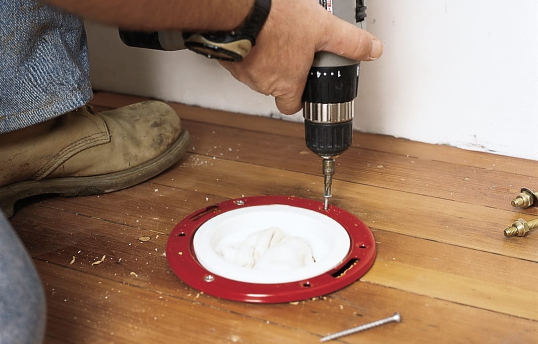 Drilling the closet flange.