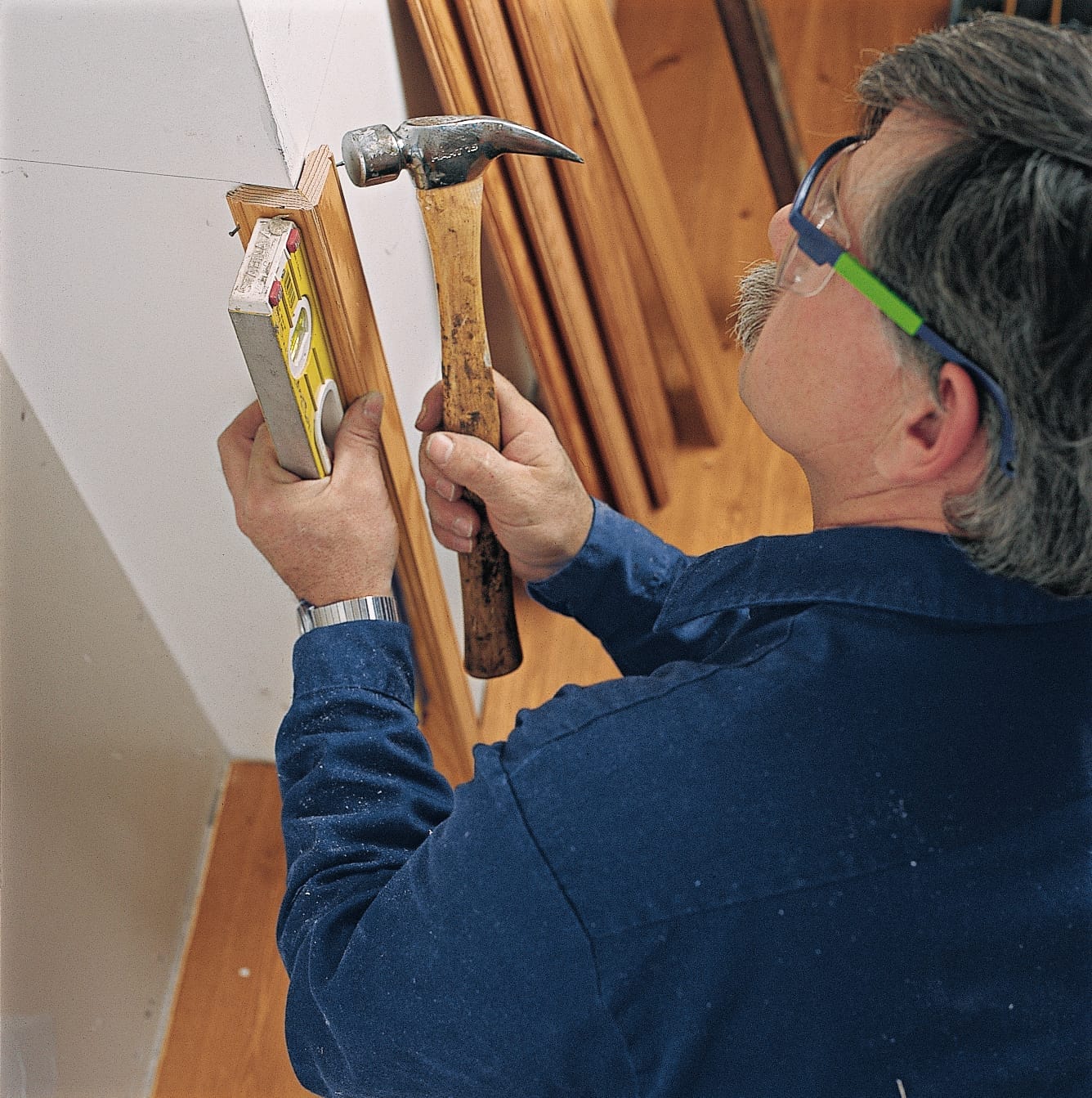 Image of a step of the beadboard wainscoting installation process, which involves starting beadboard installation at the corner of the room