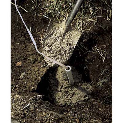 Wiring for a lamppost being run underground.