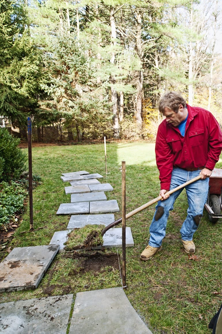 Removing grass and soil for stone path