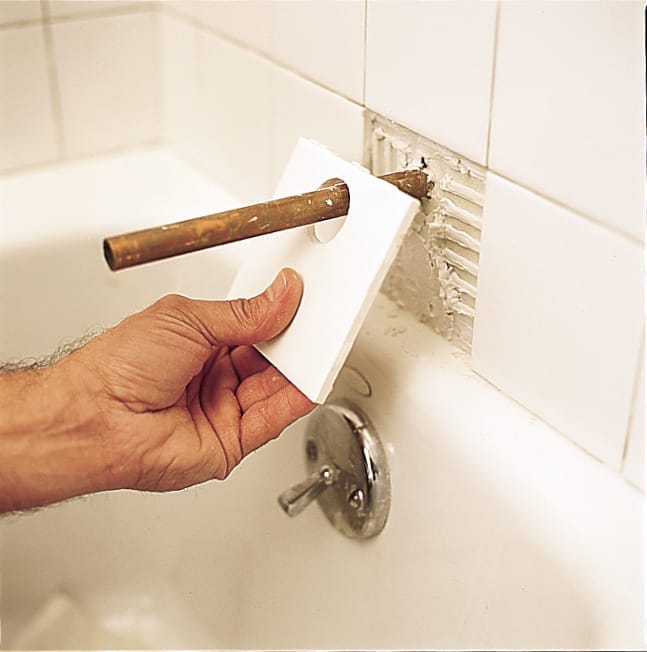 applying a tile with a hole in it over a tub fixture