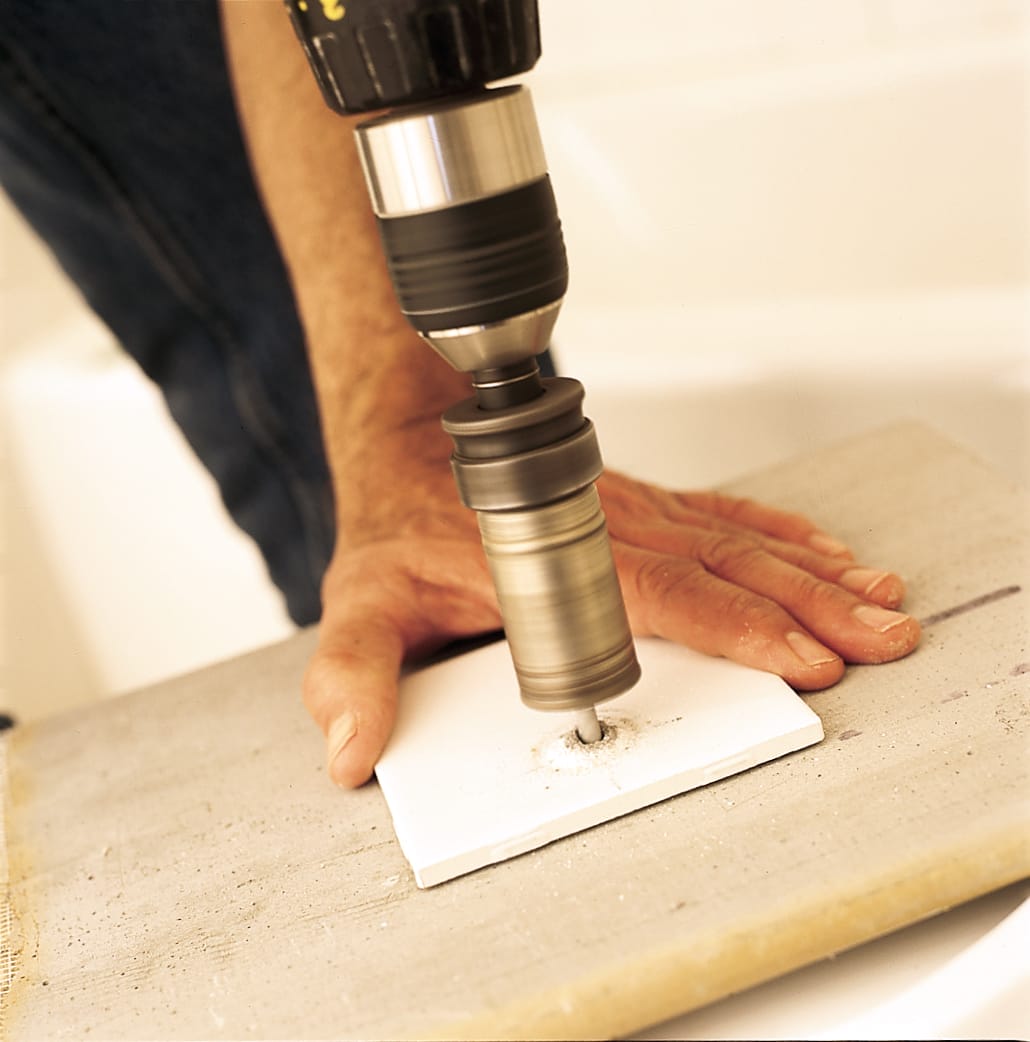 drilling in notches into a piece of tile