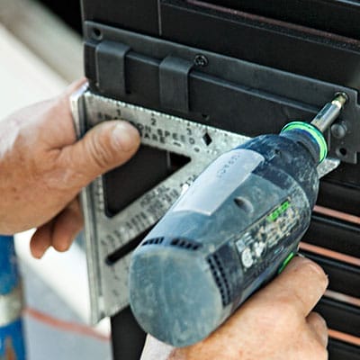 A man fastens a sliding bolt.