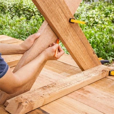 A man marks the half-lap joint.