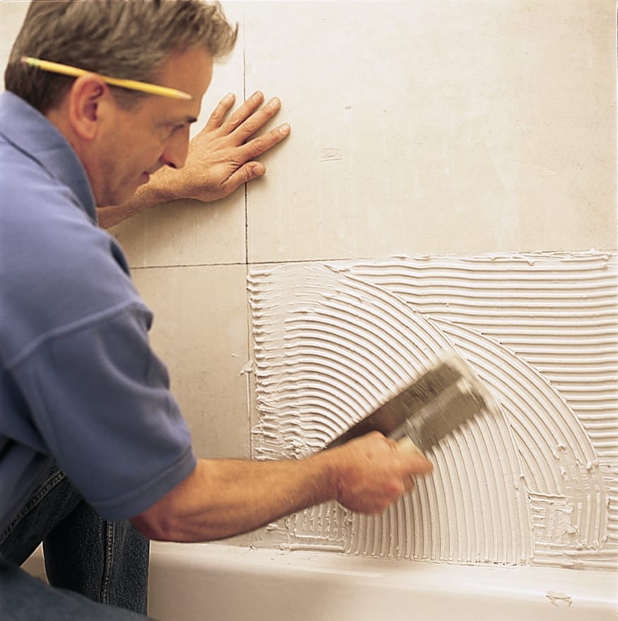 applying mastic to a tub surround