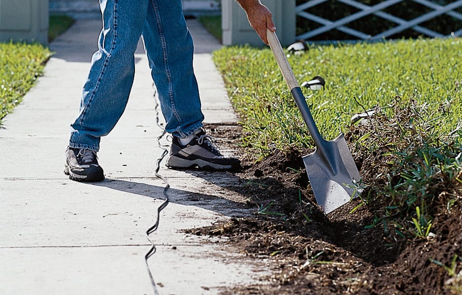 Sod is turned over for landscaping light cables.
