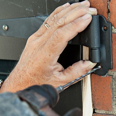 A man drills a pilot hole.