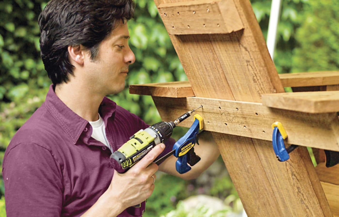 Photo of a person fastening the rear brace of a chair for a Westport chair building project. 