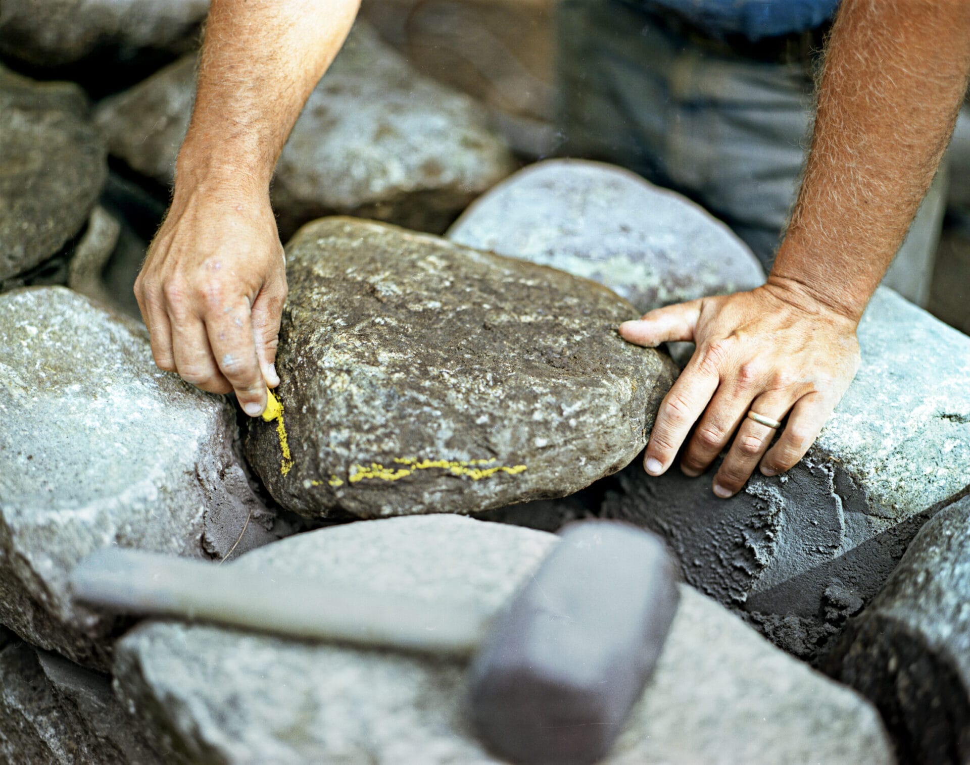 Stone being marked with chalk for shaping.