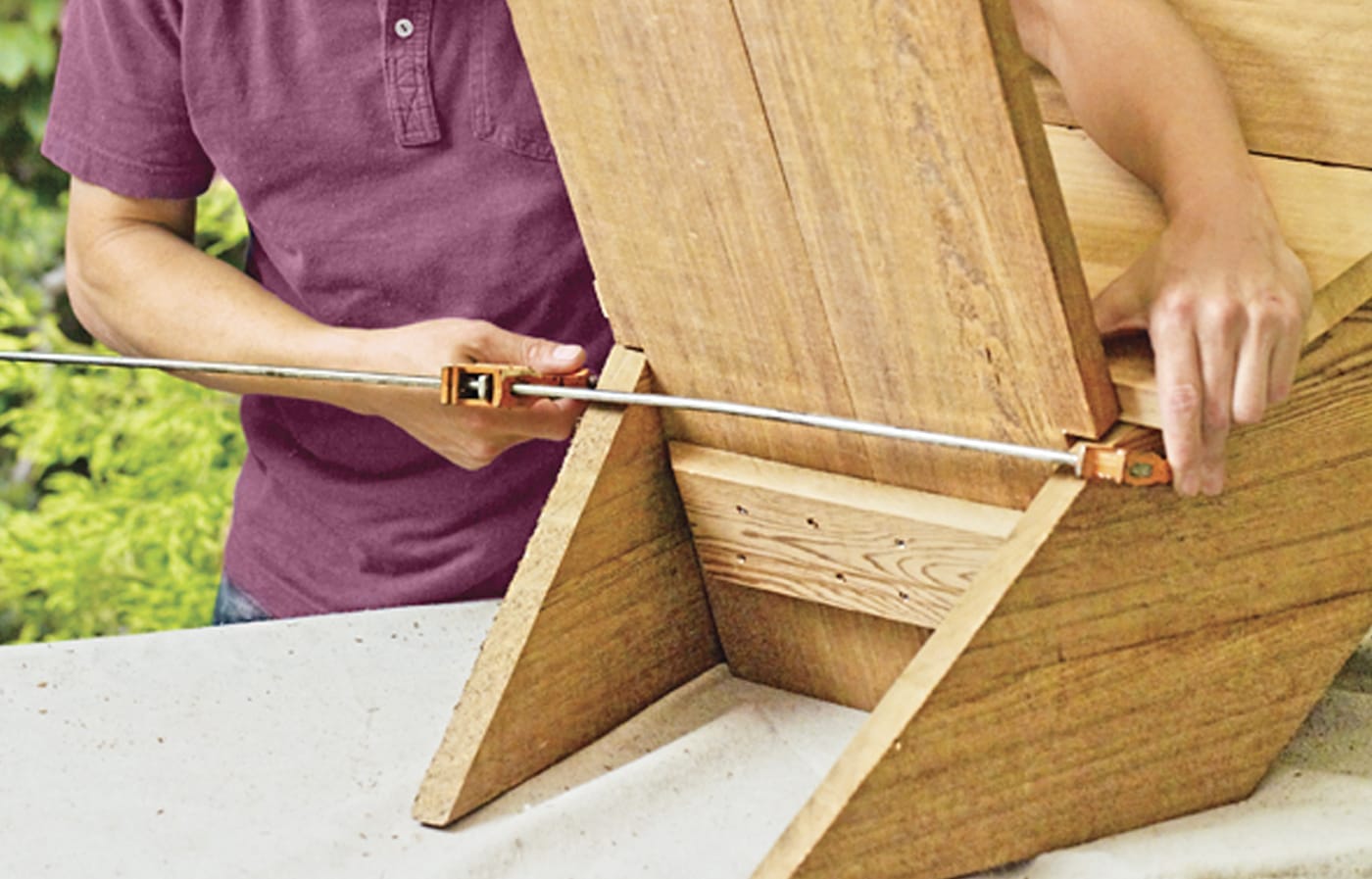 Photo of a person attaching the backrest of a chair for a Westport chair building project. 