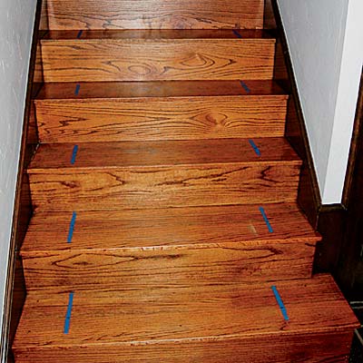 Measuring and markings are pictured on a staircase as preparation for stair runner installation.