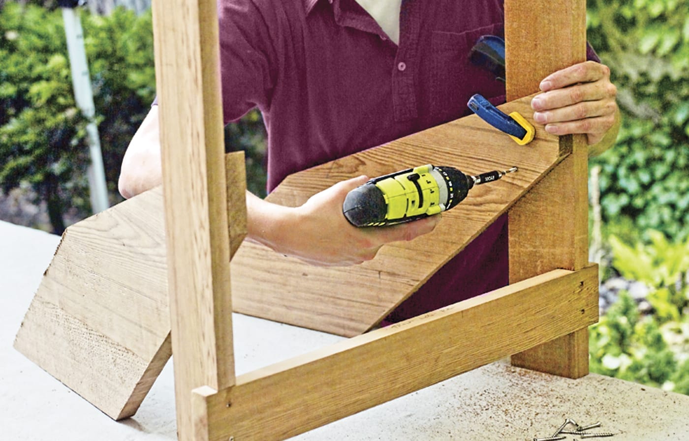 Photo of a person attaching the legs of a chair for a Westport chair building project. 