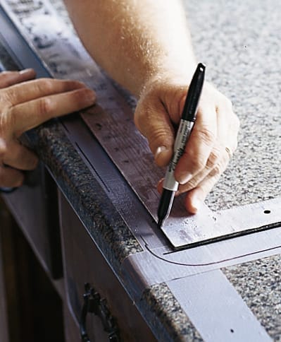 Man using Sharpie to mark corner.