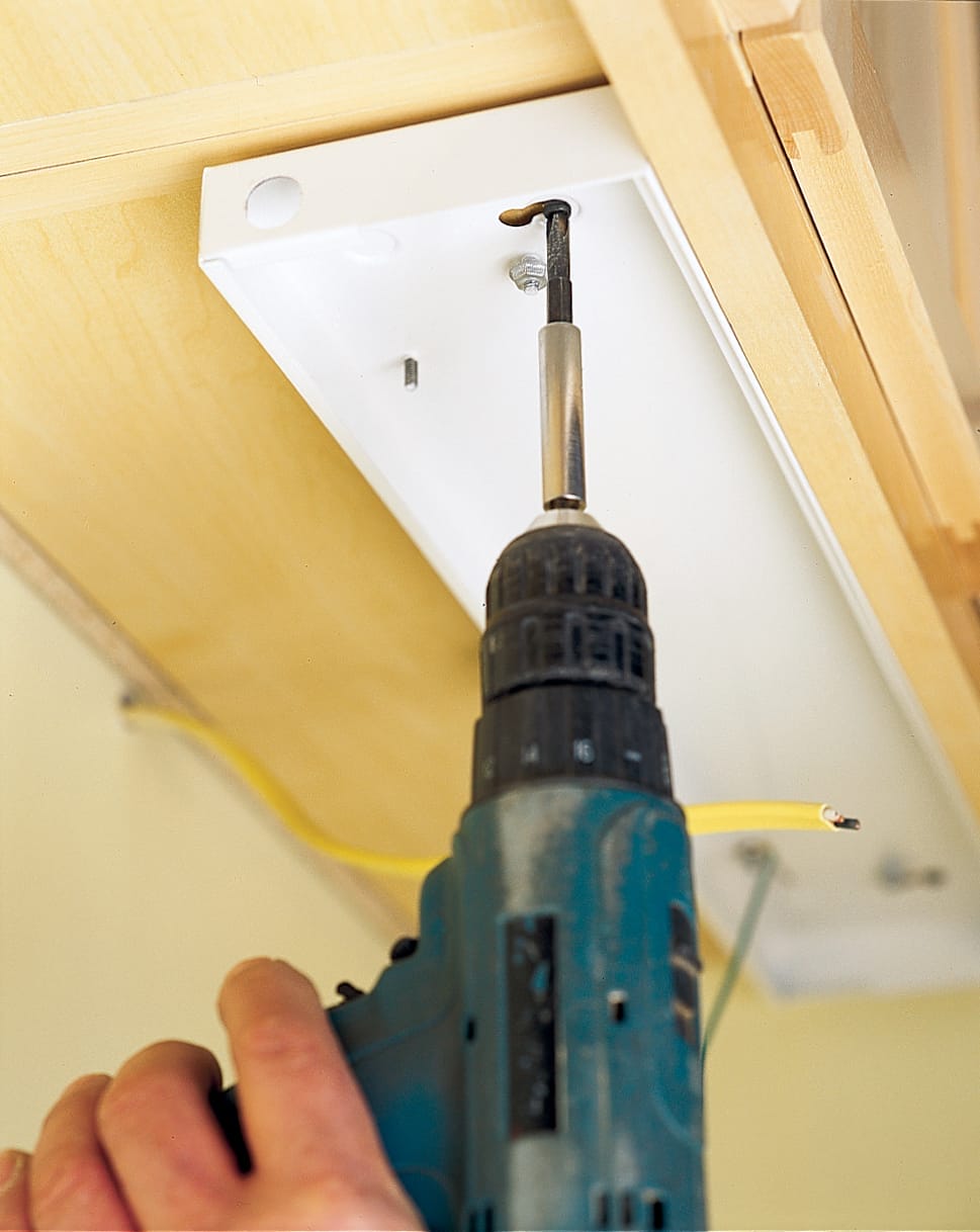Light fixtures are installed under the cabinets.